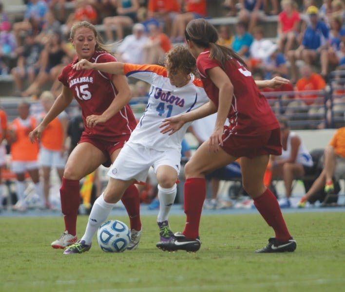 Junior outside back Taylor Travis (41) fights for the ball against Arkansas defenders Yvonne DesJarlais (15) and Evan Palmer (31) in Florida’s 4-0 win on Sept. 30 at James G. Pressly Stadium. Travis played a major role in preserving a road victory against Texas A&amp;M on Sunday.