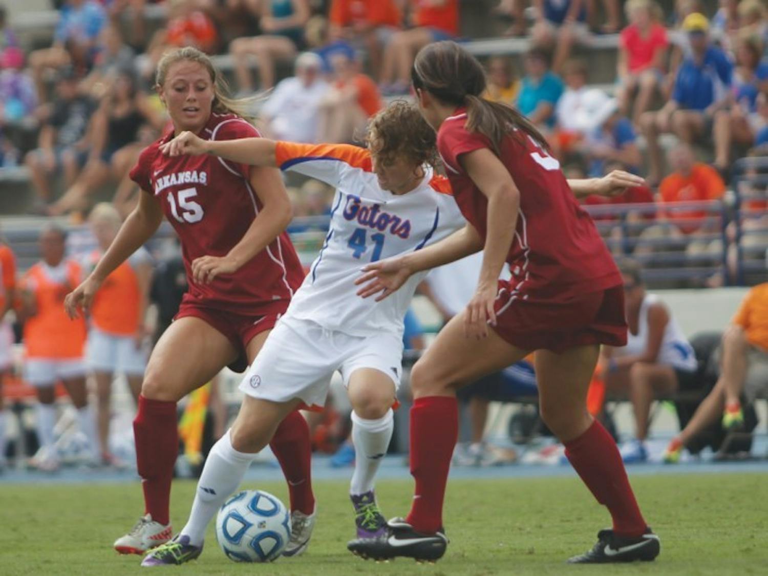Junior outside back Taylor Travis (41) fights for the ball against Arkansas defenders Yvonne DesJarlais (15) and Evan Palmer (31) in Florida’s 4-0 win on Sept. 30 at James G. Pressly Stadium. Travis played a major role in preserving a road victory against Texas A&amp;M on Sunday.