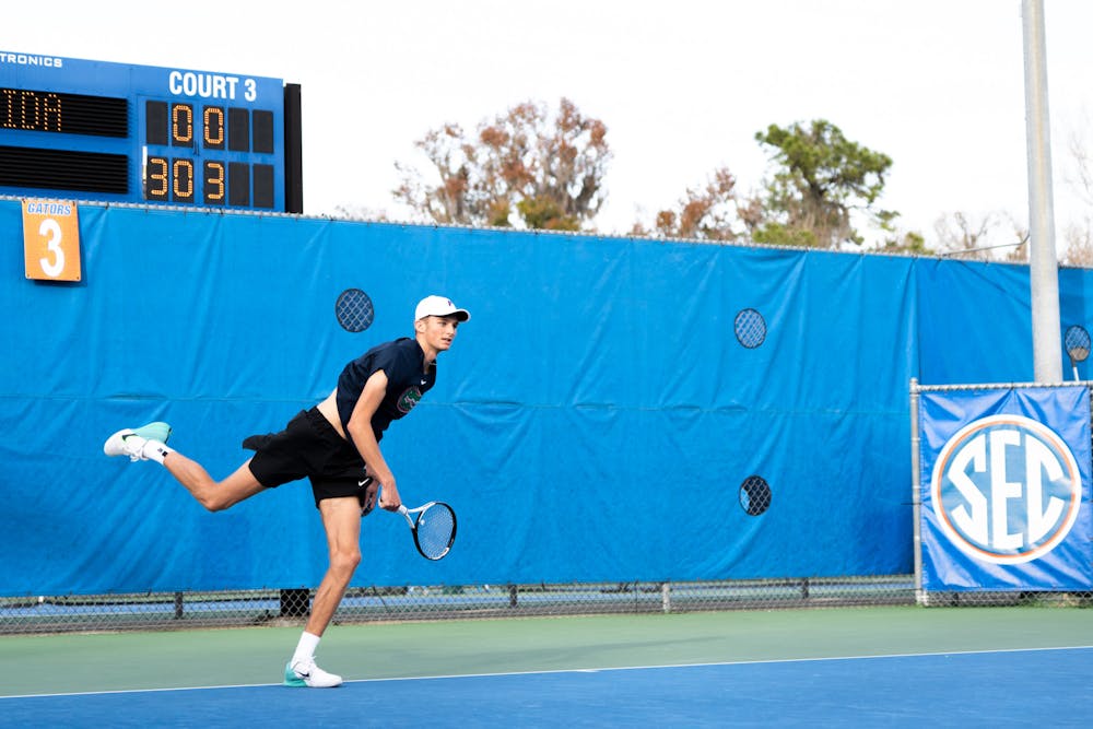 <p>Florida tennis player Henry Jefferson finishes a swing during a doubles match against North Florida on Friday, Jan. 19, 2024. </p>