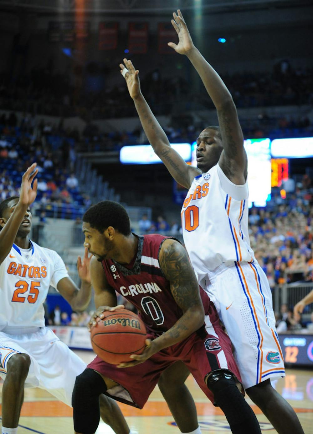 <p>Dorian Finney-Smith (right) defends USC’s Sindarius Thornwell (middle) during Florida’s’ 74-58 win on Jan. 8 in the O’Connell Center. Finney-Smith led UF in points in its win against Arkansas on Saturday.</p>