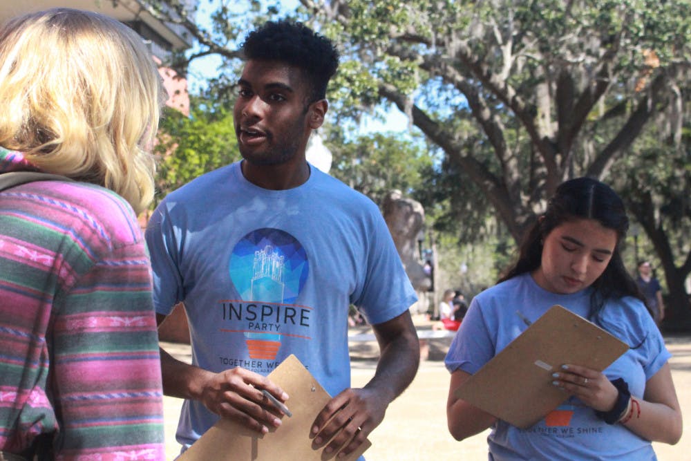 Che John, a 19-year-old UF finance sophomore, and Maria Espinoza, a 19-year-old UF criminology sophomore, talked to students Tuesday afternoon on Turlington Plaza. John and Espinoza are both members of Inspire Party, and they spent the afternoon reaching out to students about the upcoming Student Government elections. 