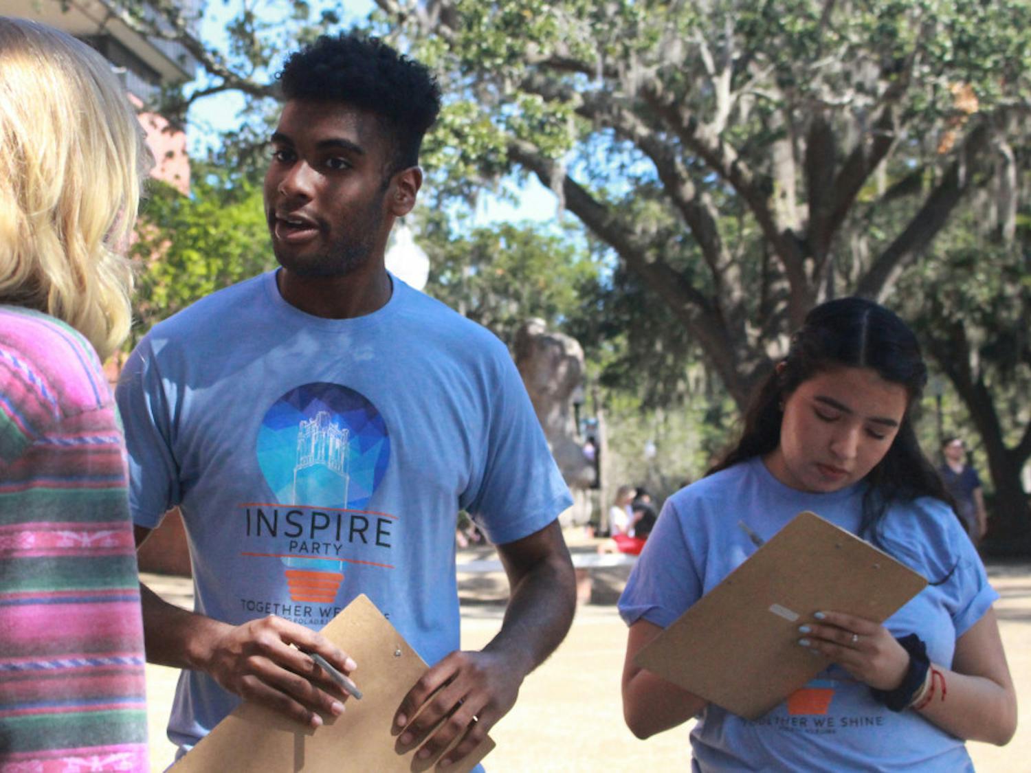 Che John, a 19-year-old UF finance sophomore, and Maria Espinoza, a 19-year-old UF criminology sophomore, talked to students Tuesday afternoon on Turlington Plaza. John and Espinoza are both members of Inspire Party, and they spent the afternoon reaching out to students about the upcoming Student Government elections.