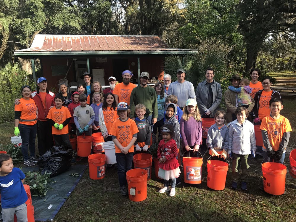 With the help of friends and family, Cub Scout Pack 127 takes part in the cleanup of Ardisia Crenata  in woodlands around the city of Gainesville. Ana Escalante / Alligator Contributor
