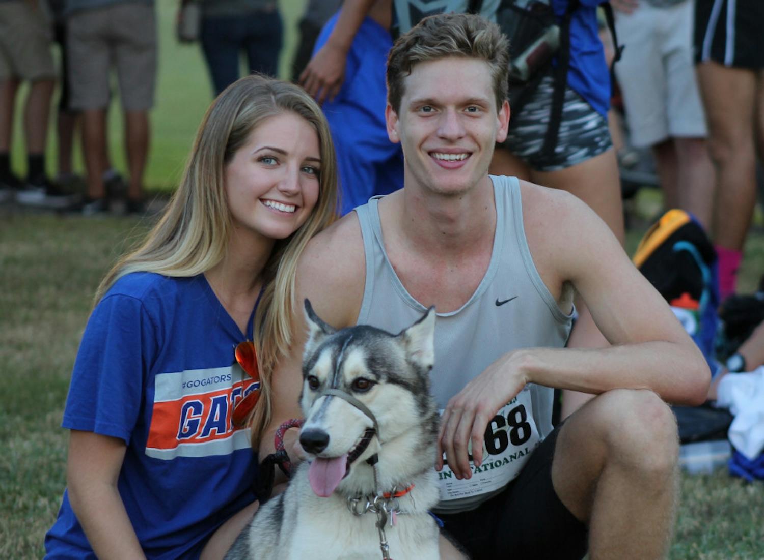 UF cross country runner Jack Rogers (right), his girlfriend, Madison Dixon (left), Jack's mother's dog, Mateo, pose for a photo after the 2015 USF invitational. 