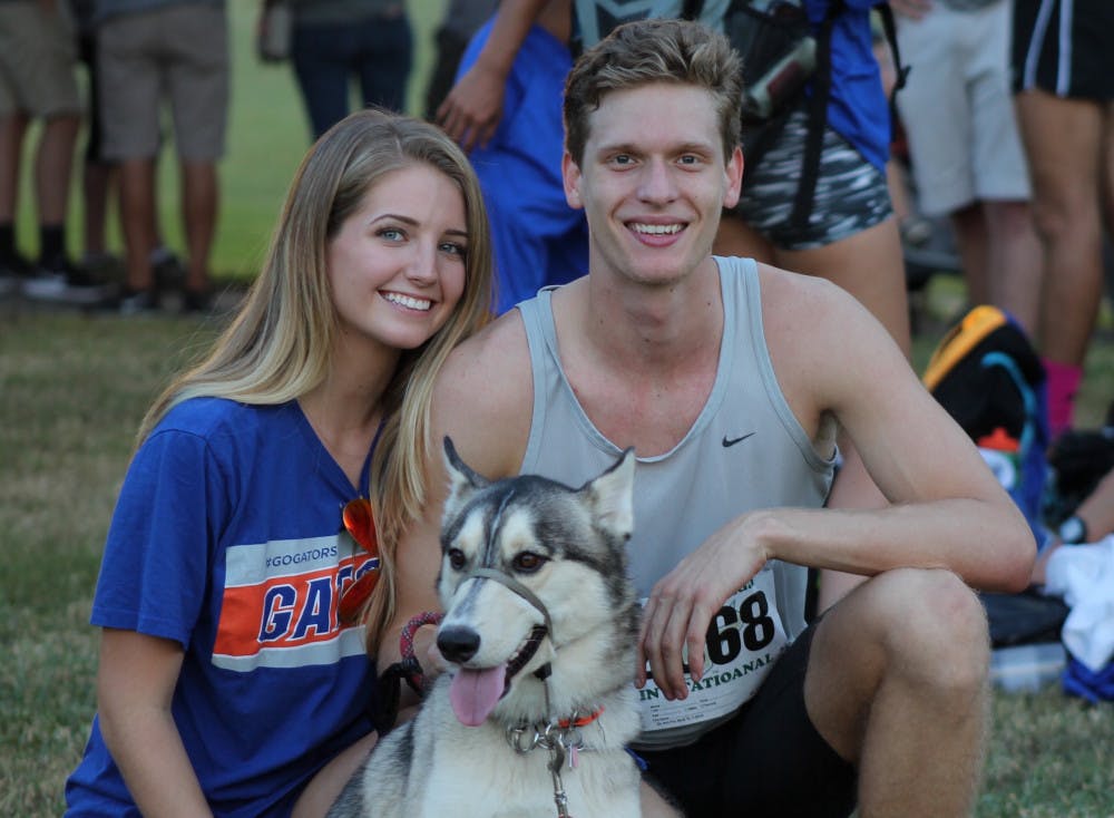 <p><span>UF cross country runner Jack Rogers (right), his girlfriend, Madison Dixon (left), Jack's mother's dog, Mateo, pose for a photo after the 2015 USF invitational.</span></p><p><span style="color: #222222; font-family: arial, sans-serif; font-size: 12.8px;"> </span></p>