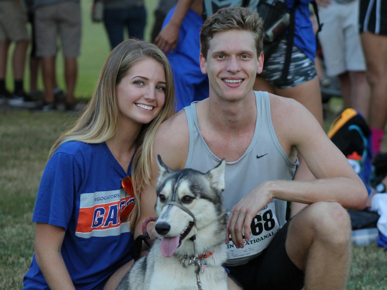 UF cross country runner Jack Rogers (right), his girlfriend, Madison Dixon (left), Jack's mother's dog, Mateo, pose for a photo after the 2015 USF invitational. 