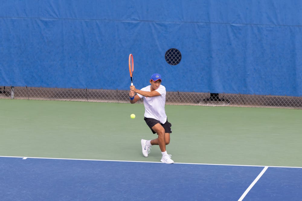 Jeremy Jin hits a backhand shot in the Gators men's tennis team's match against the Citadel on Friday, January 19, 2024.