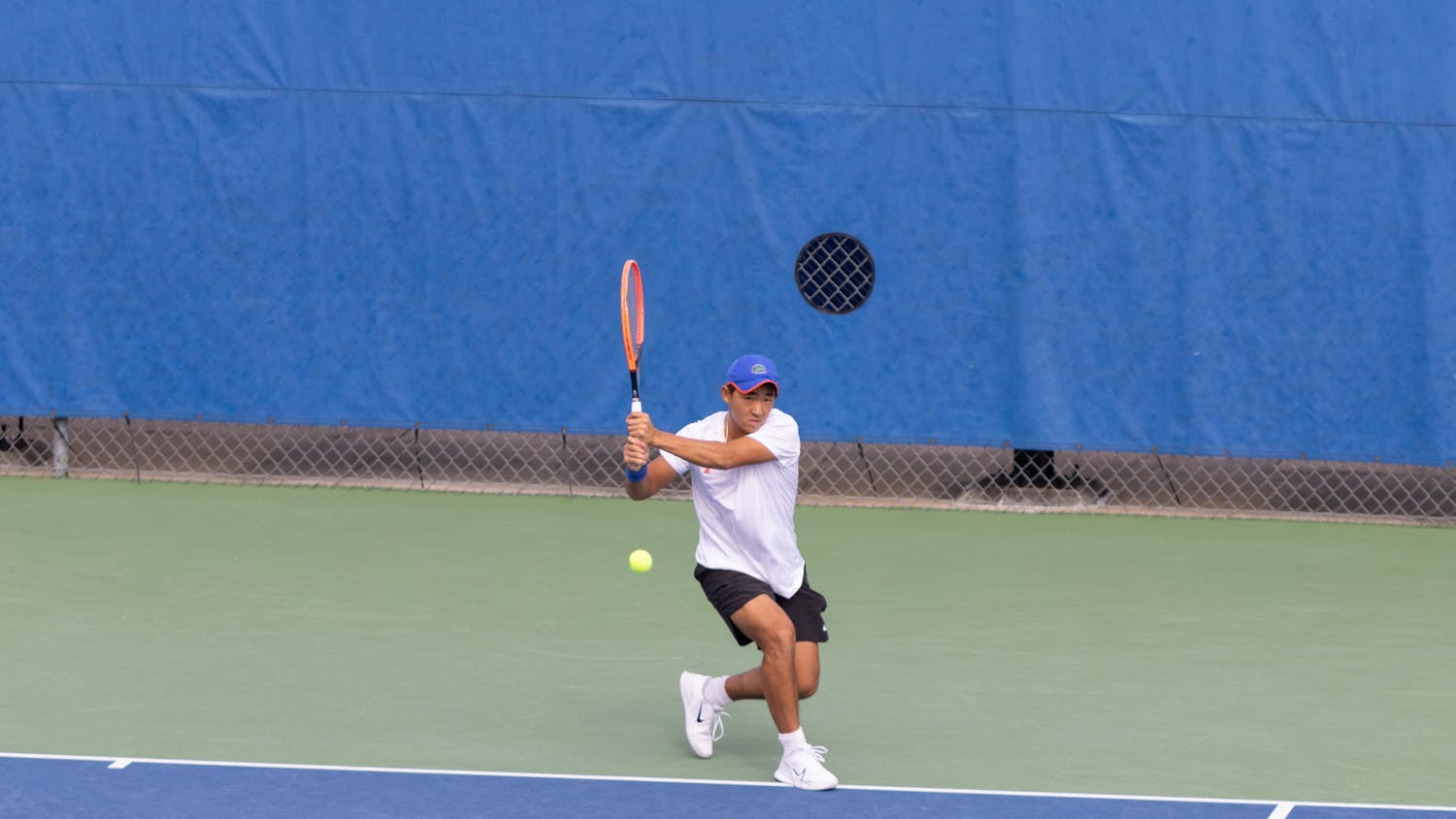 Jeremy Jin hits a backhand shot in the Gators men's tennis team's match against the Citadel on Friday, January 19, 2024.
