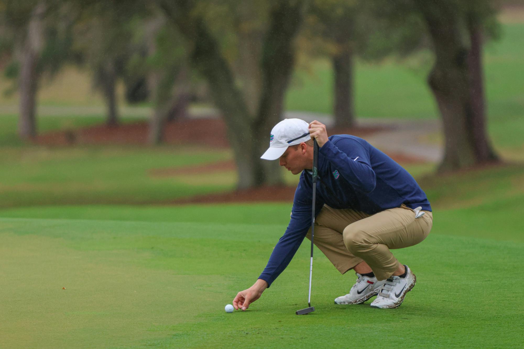 Florida senior John DuBois lines up a putt in at the Vystar Credit Union Gators Invitational Sunday, Feb. 12, 2023.