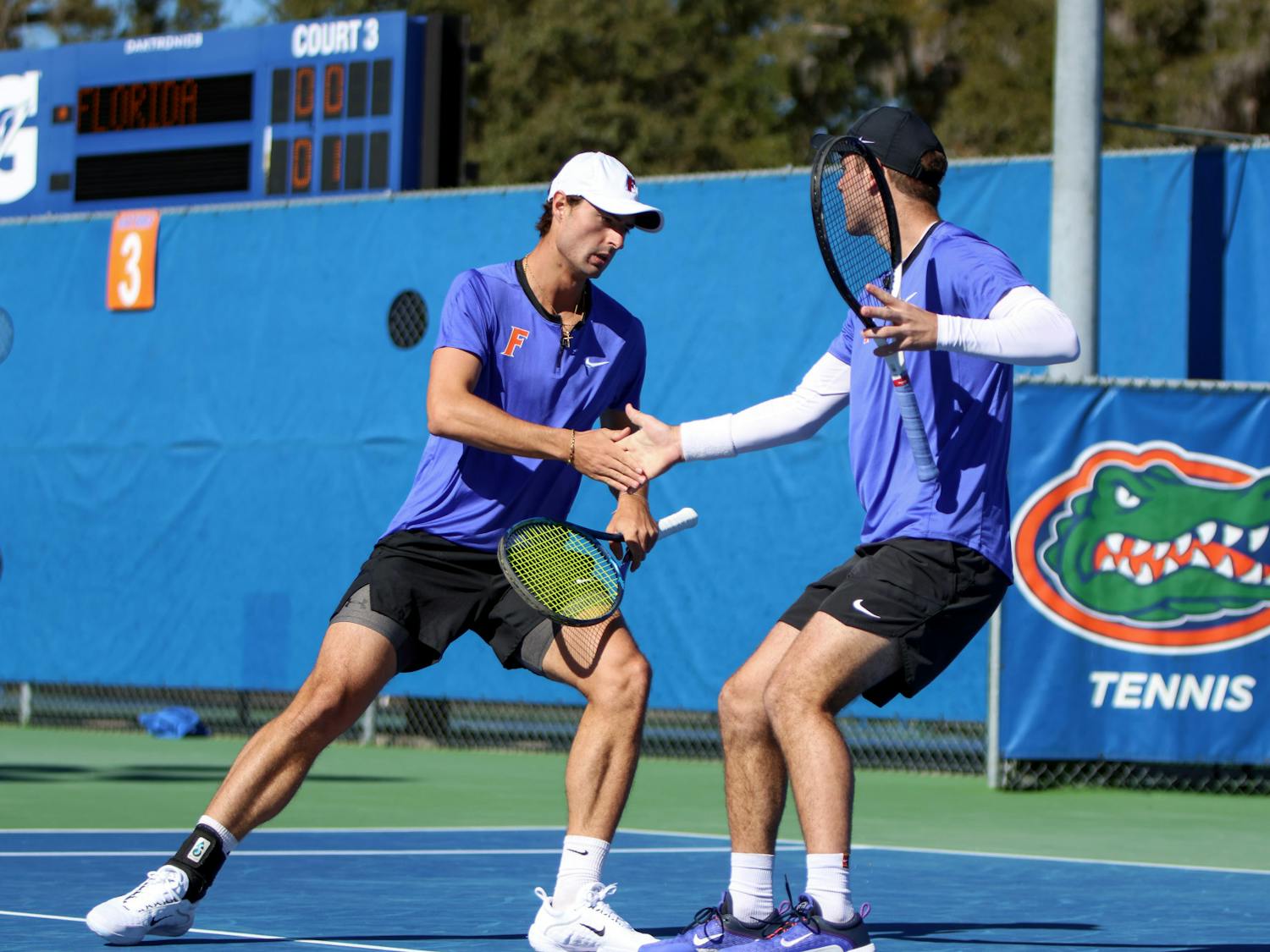 Gators Axel Nefve (left) and Will Grant (right) share the court in their doubles match during Florida’s 5-2 loss to Texas Sunday, Jan. 15, 2023. Nefve and Grant lost to the No. 7-ranked pair of Longhorns Cleeve Harper and Eliot Spizzirri.