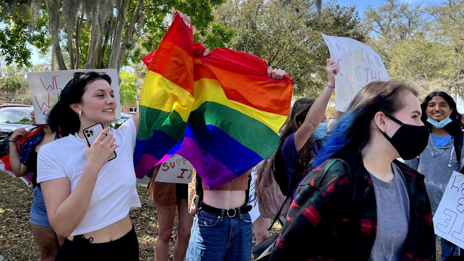 Gainesville High School students protest outside their school's campus, waving their flags for oncoming traffic in opposition to Florida's ‘Don’t Say Gay’ bill, which would effectively ban discussion of LGBTQ+ issues in elementary schools and stigmatize it in upper grade levels.