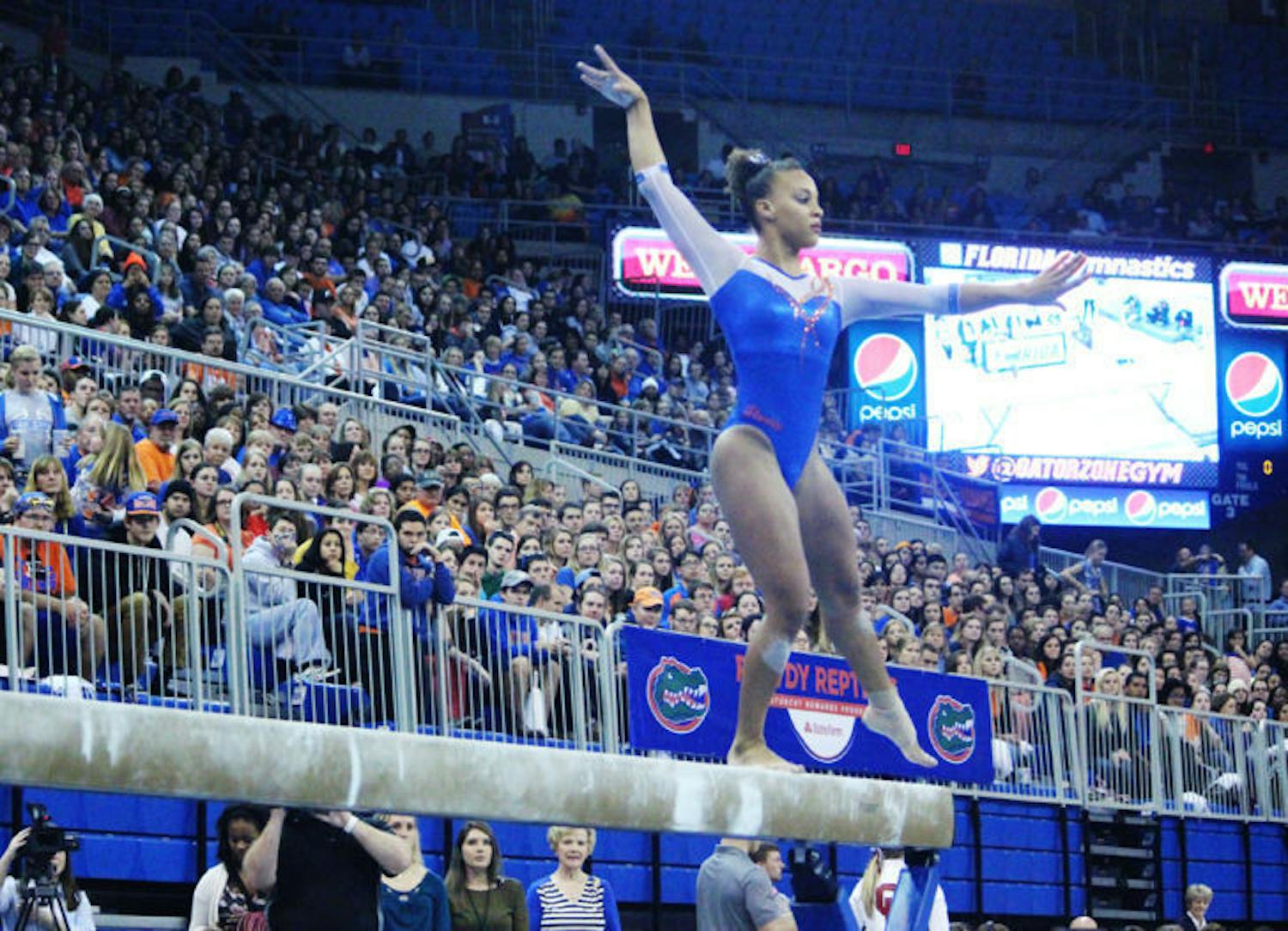 Kytra Hunter performs a balance beam routine during Florida’s 197.875-197.225 win against Oklahoma on Friday in the O’Connell Center. Hunter notched the first consecutive 10s on the floor in UF history.