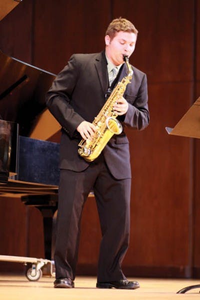 First-year music graduate student Don-Paul Kahl plays the saxophone at the University Auditorium Wednesday. Kahl is vying for a solo with the UF Orchestra in the UF School of Music Concerto Competition.