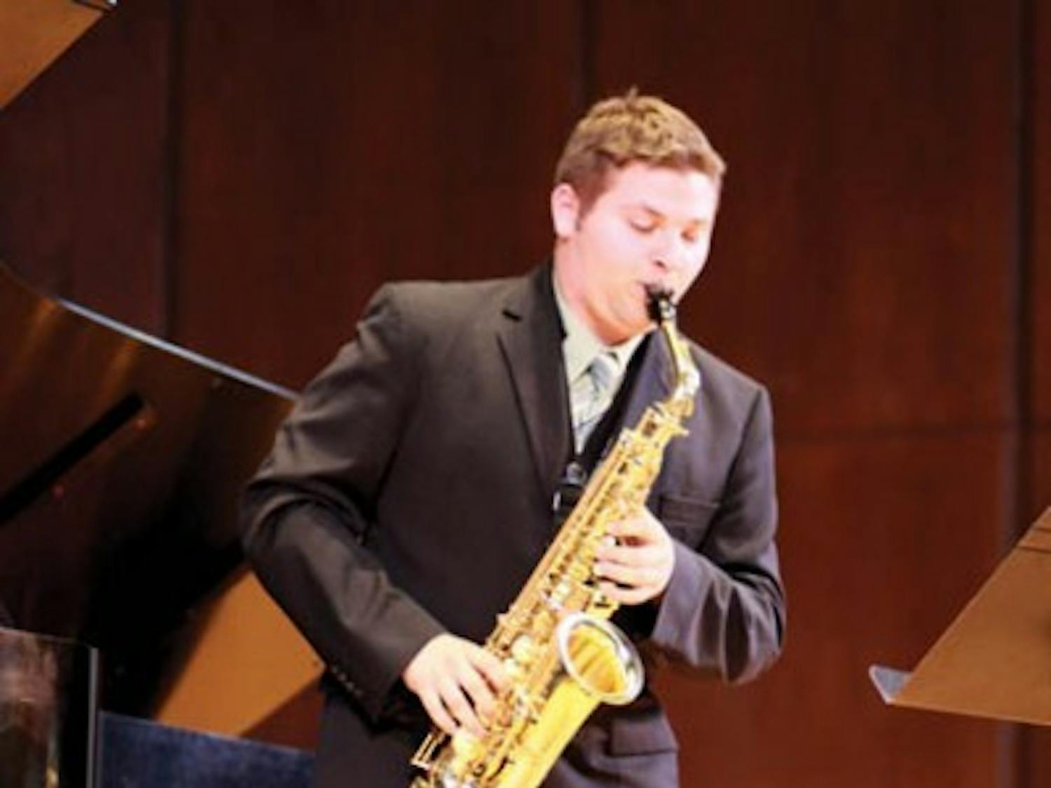 First-year music graduate student Don-Paul Kahl plays the saxophone at the University Auditorium Wednesday. Kahl is vying for a solo with the UF Orchestra in the UF School of Music Concerto Competition.