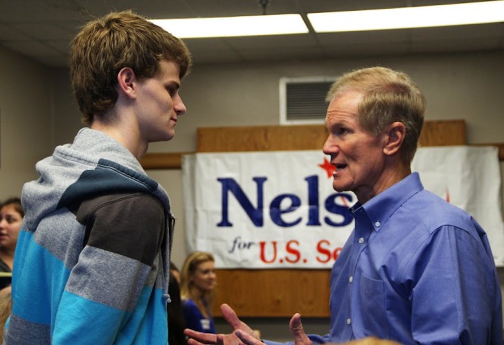 <p>Sen. Bill Nelson greets Kenny Heidegger, an 18-year-old political science freshman. Nelson held a discussion and a Q-and-A session at which students asked questions pertaining to the environment and how to urge the average voter away from bipartisanship.</p>