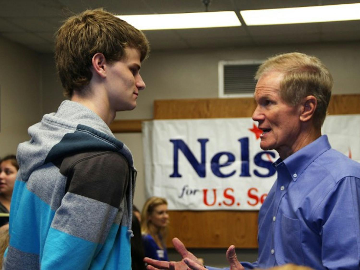 Sen. Bill Nelson greets Kenny Heidegger, an 18-year-old political science freshman. Nelson held a discussion and a Q-and-A session at which students asked questions pertaining to the environment and how to urge the average voter away from bipartisanship.