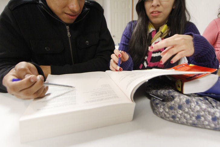 UF accounting freshman Vanessa Colchado, 19, helps a student prepare for the GED exams at Iglesia Adventista del Septimo Dia de Gainesville on Tuesday evening.