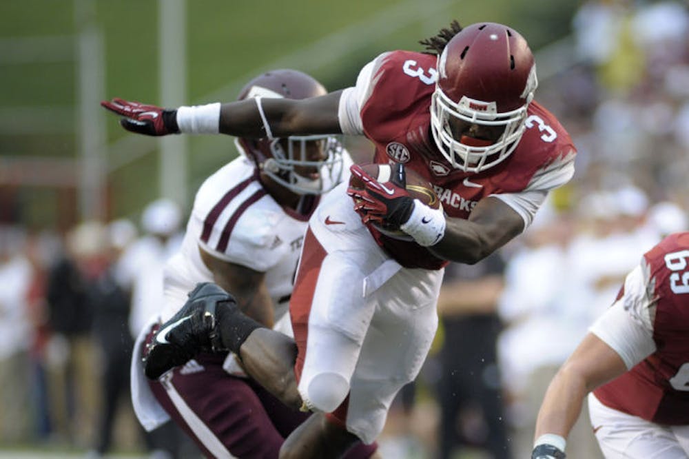 <p>Arkansas tailback Alex Collins (3) runs past Texas A&amp;M linebacker Nate Askew during the first quarter of a 45-33 loss to the Aggies on Saturday in Fayetteville, Ark. Collins is second in the Southeastern Conference in rushing yards per game.</p>