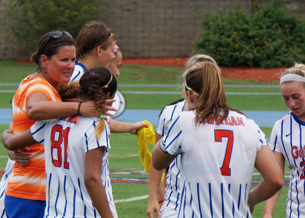 <p>UF soccer coach Becky Burleigh puts her arm around defender Rachelle Smith (81) following Florida's 3-2 win against Florida State on Aug. 30, 2015, at James G. Pressly Stadium.</p>