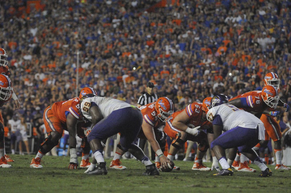 <p>UF center Cam Dillard (54) prepares to hike the ball during Florida's 31-24 win against East Carolina on Sept. 12, 2015, at Ben Hill Griffin Stadium.</p>