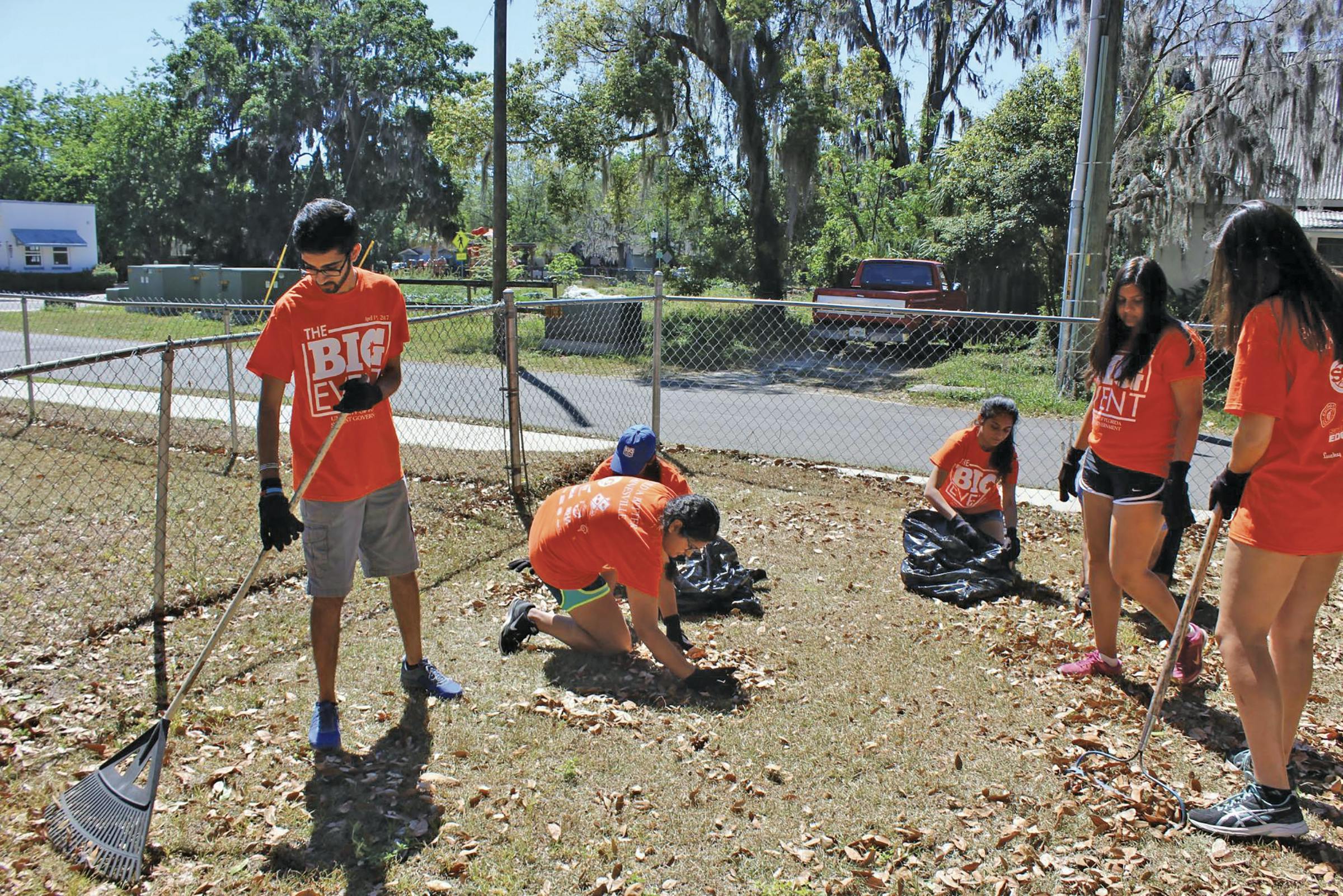 Amol Patadia, a 20-year-old UF biomedical engineering sophomore, rakes fallen leaves behind the home of a visually impaired woman in Gainesville’s Porters Community on Saturday as a part of The Big Event, a daylong service event organized by UF Student Government. About 760 students participated at about 45 locations across Gainesville. 