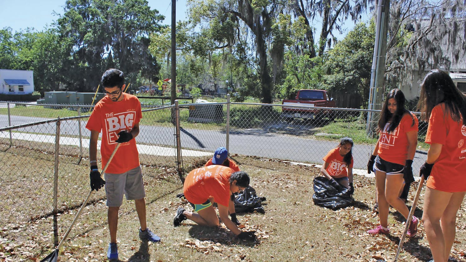 Amol Patadia, a 20-year-old UF biomedical engineering sophomore, rakes fallen leaves behind the home of a visually impaired woman in Gainesville’s Porters Community on Saturday as a part of The Big Event, a daylong service event organized by UF Student Government. About 760 students participated at about 45 locations across Gainesville.