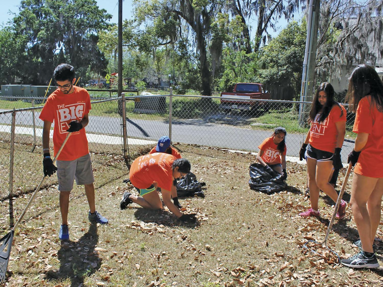 Amol Patadia, a 20-year-old UF biomedical engineering sophomore, rakes fallen leaves behind the home of a visually impaired woman in Gainesville’s Porters Community on Saturday as a part of The Big Event, a daylong service event organized by UF Student Government. About 760 students participated at about 45 locations across Gainesville. 