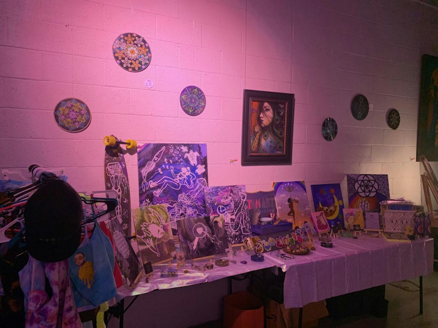 With rainbows and flashing colors of the projector on her art, Julia Monteiro showed her art at the Goddess Visions Artwalk Exhibition.&nbsp;