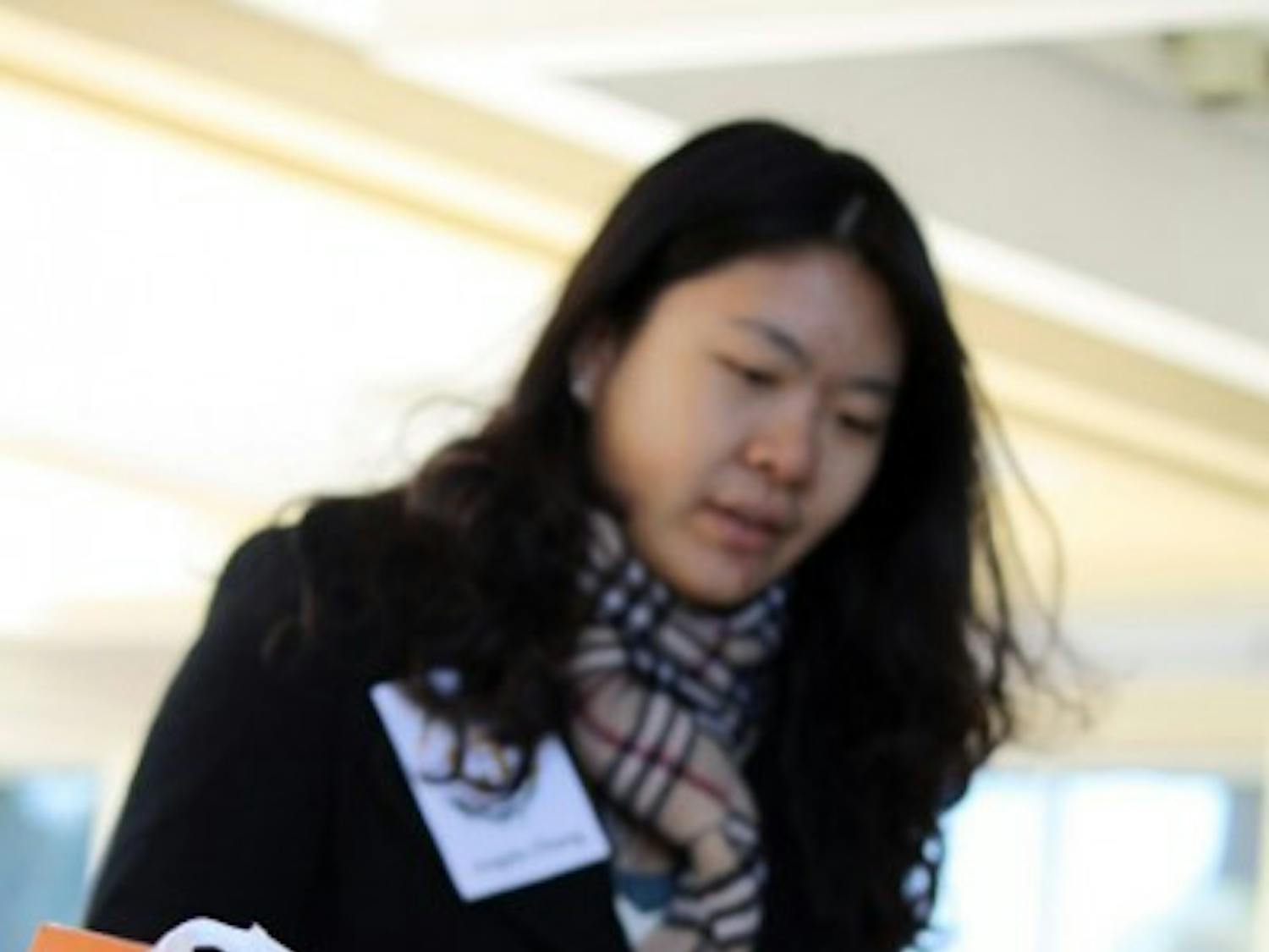 Angela Zhang collects canned food on the Reitz Union Colonnade on Friday during a food drive hosted by the the Center of Leadership and Service and The 15 percent.
