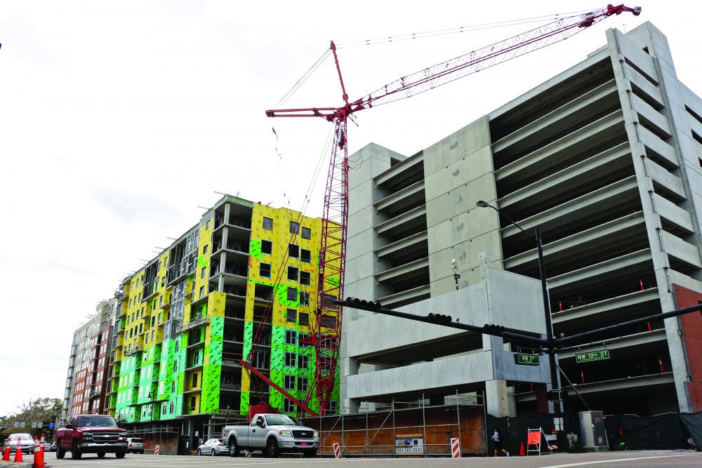 The three buildings of The Standard at Gainesville complex stand along 13th Street. From left: The first building will be for apartments, the second building will be an AC Hotels by Marriott, and the third building, which is near completion, will be a parking garage. 
