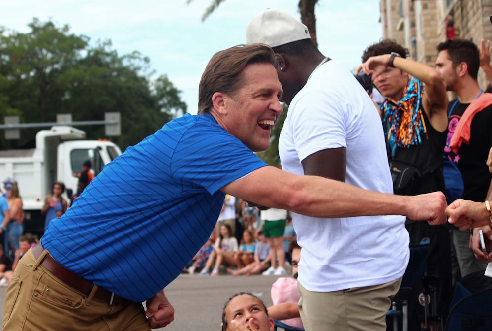  UF President Ben Sasse interacts with parade goers during the Homecoming Parade on Friday, Oct. 6, 2023.