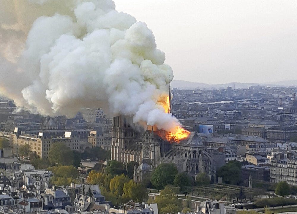 In this image made available on Tuesday April 16, 2019 flames and smoke rise from the blaze at Notre Dame cathedral in Paris, Monday, April 15, 2019. An inferno that raged through Notre Dame Cathedral for more than 12 hours destroyed its spire and its roof but spared its twin medieval bell towers, and a frantic rescue effort saved the monument's "most precious treasures," including the Crown of Thorns purportedly worn by Jesus, officials said Tuesday. (AP Photo/Cedric Herpson)