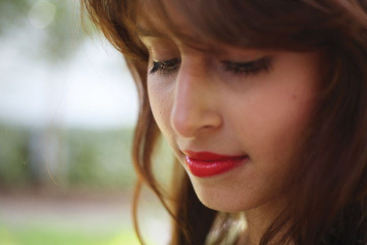 Telecommunication junior Andrea Solis, 20, smiles with red lipstick Wednesday afternoon. A recent study found that men fixated on the lips of women wearing red lipstick for about seven seconds.