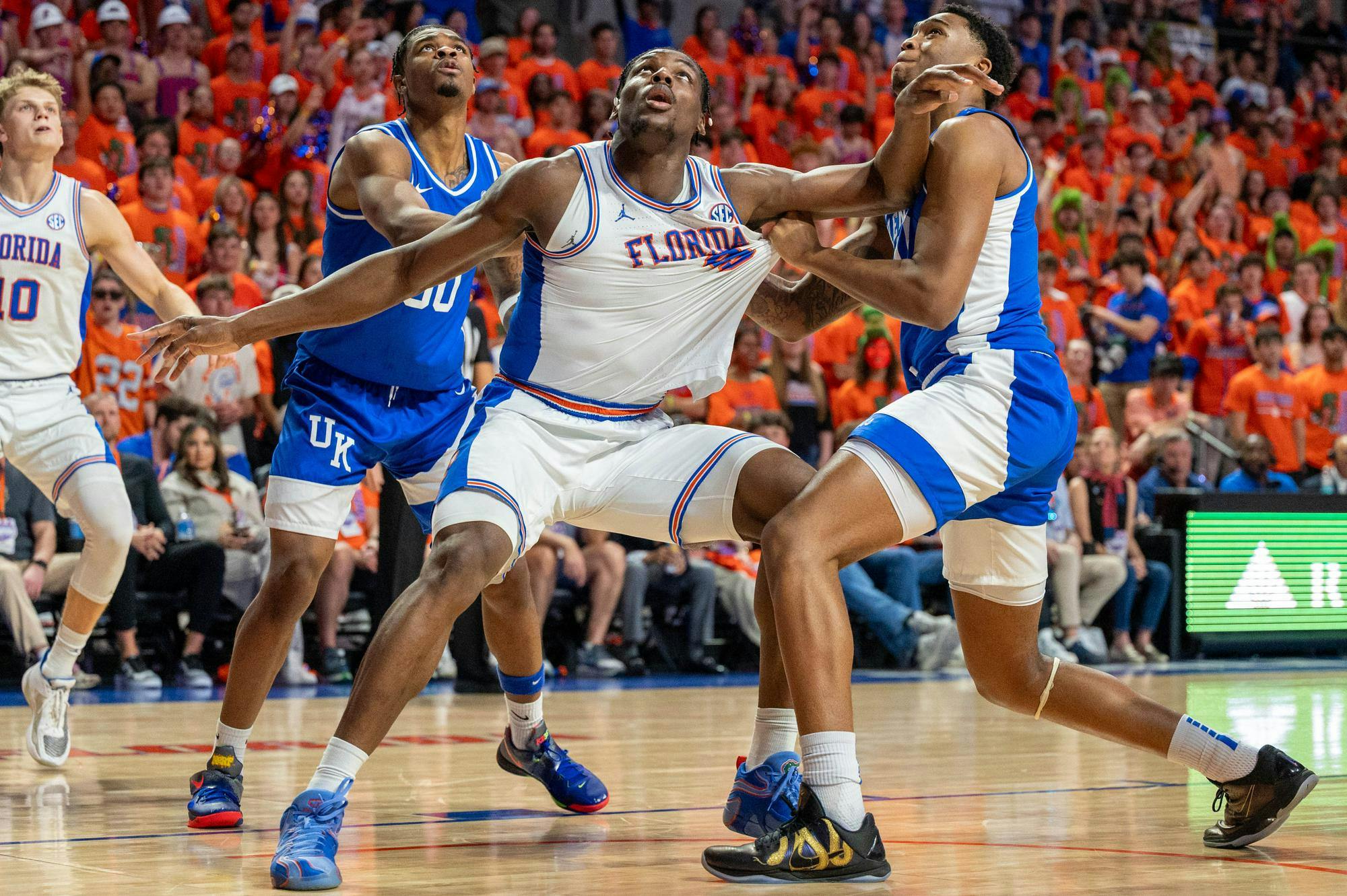 Florida center Rueben Chinyelu (9) reaches for the rebound against two Kentucky guards during the first half of an NCAA college basketball game, Saturday, Feb. 14, 2026 at Exactech Arena in Gainesville, Fla.