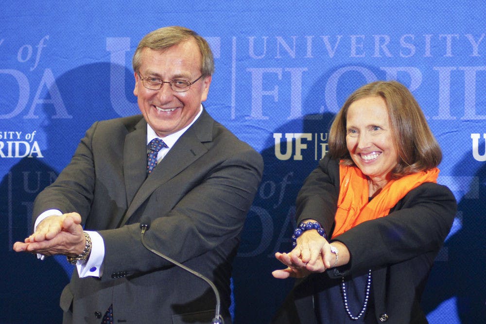 Kent Fuchs and his wife, Linda, Gator Chomp after the Cornell University provost was named UF’s 12th president at Emerson Alumni Hall on Wednesday.