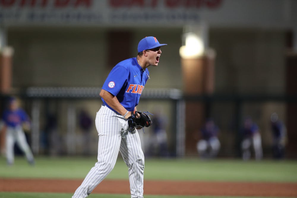<p>Freshman Carsten Finnvold celebrates on the mound during his performance against Oklahoma June 5, 2022. Finnvold sat down all 27 batters in the win.</p>
