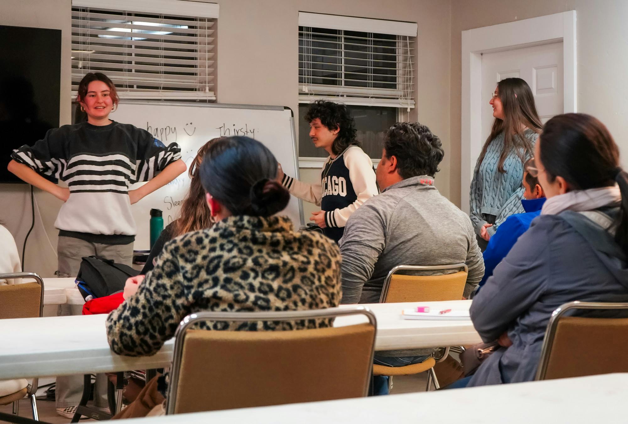 (From left to right) Volunteers Daniela Gray, Elijah Zarsadias and Nicole Lunsford teach English words to describe emotion and feelings on Thursday, Jan. 23, 2025. 