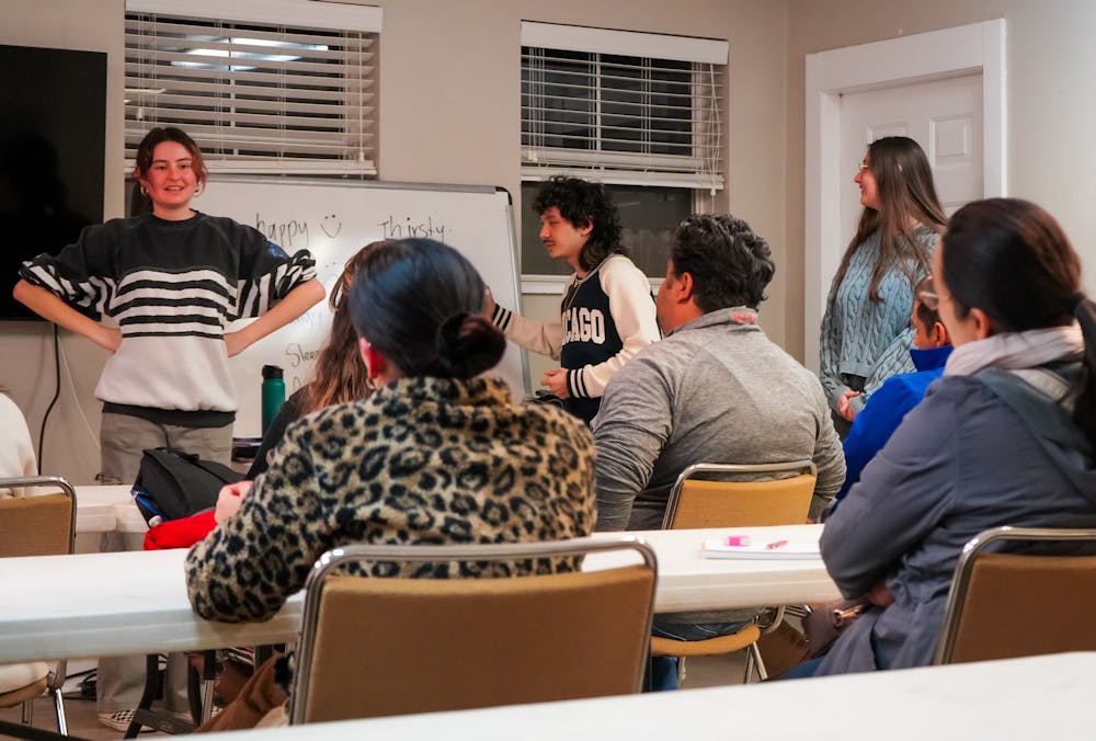 <p>(From left to right) Volunteers Daniela Gray, Elijah Zarsadias and Nicole Lunsford teach English words to describe emotion and feelings on Thursday, Jan. 23, 2025. </p>