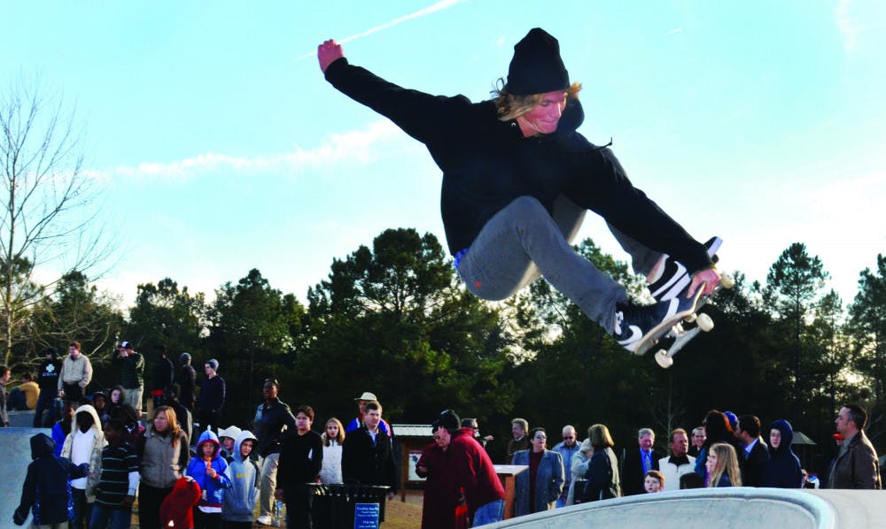 Aaron Devlin, a member of the Gator Longboard Club, performs a skateboarding trick at the new Possum Creek skatepark during the ribbon cutting ceremony Thursday.