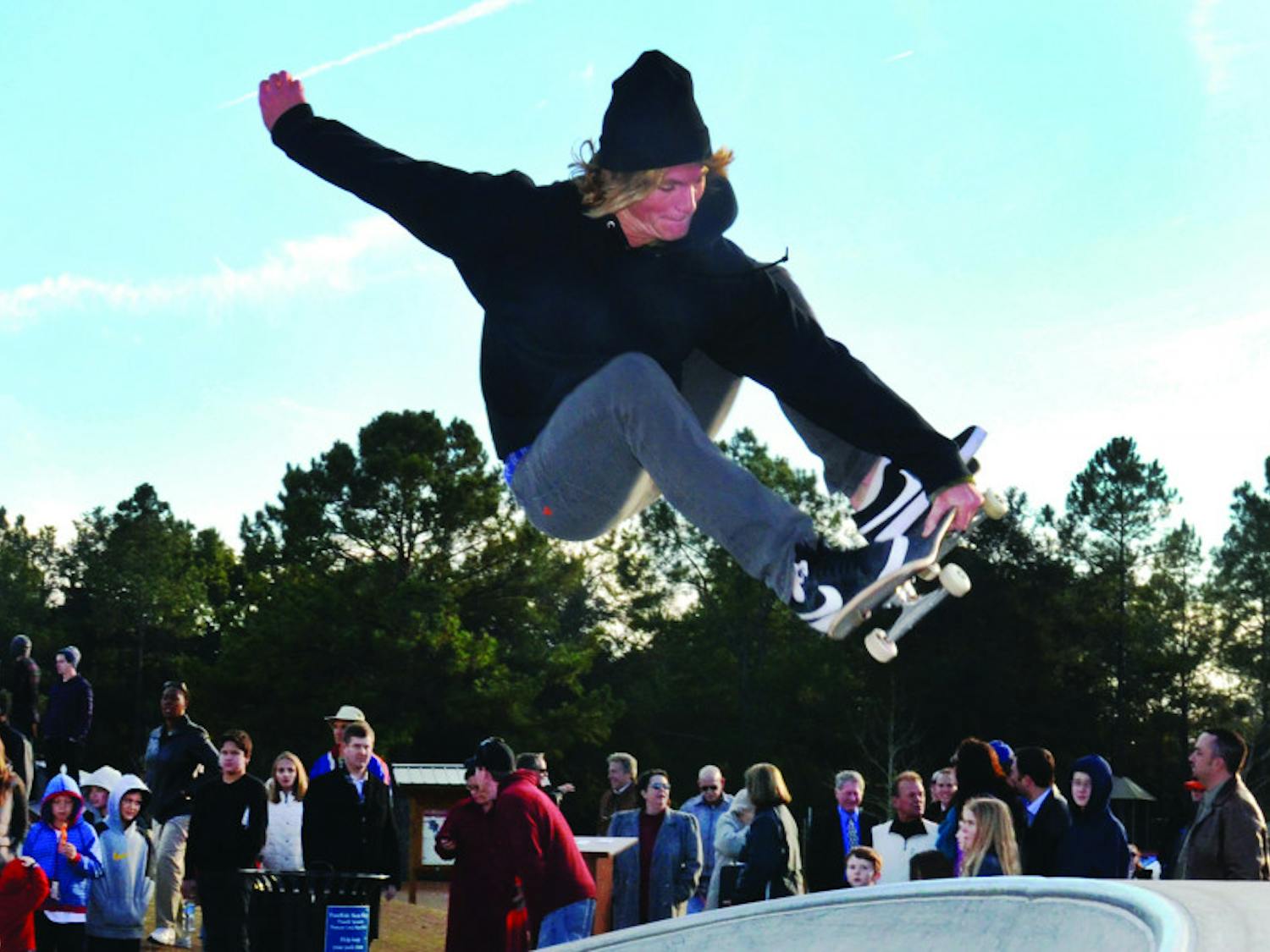 Aaron Devlin, a member of the Gator Longboard Club, performs a skateboarding trick at the new Possum Creek skatepark during the ribbon cutting ceremony Thursday.