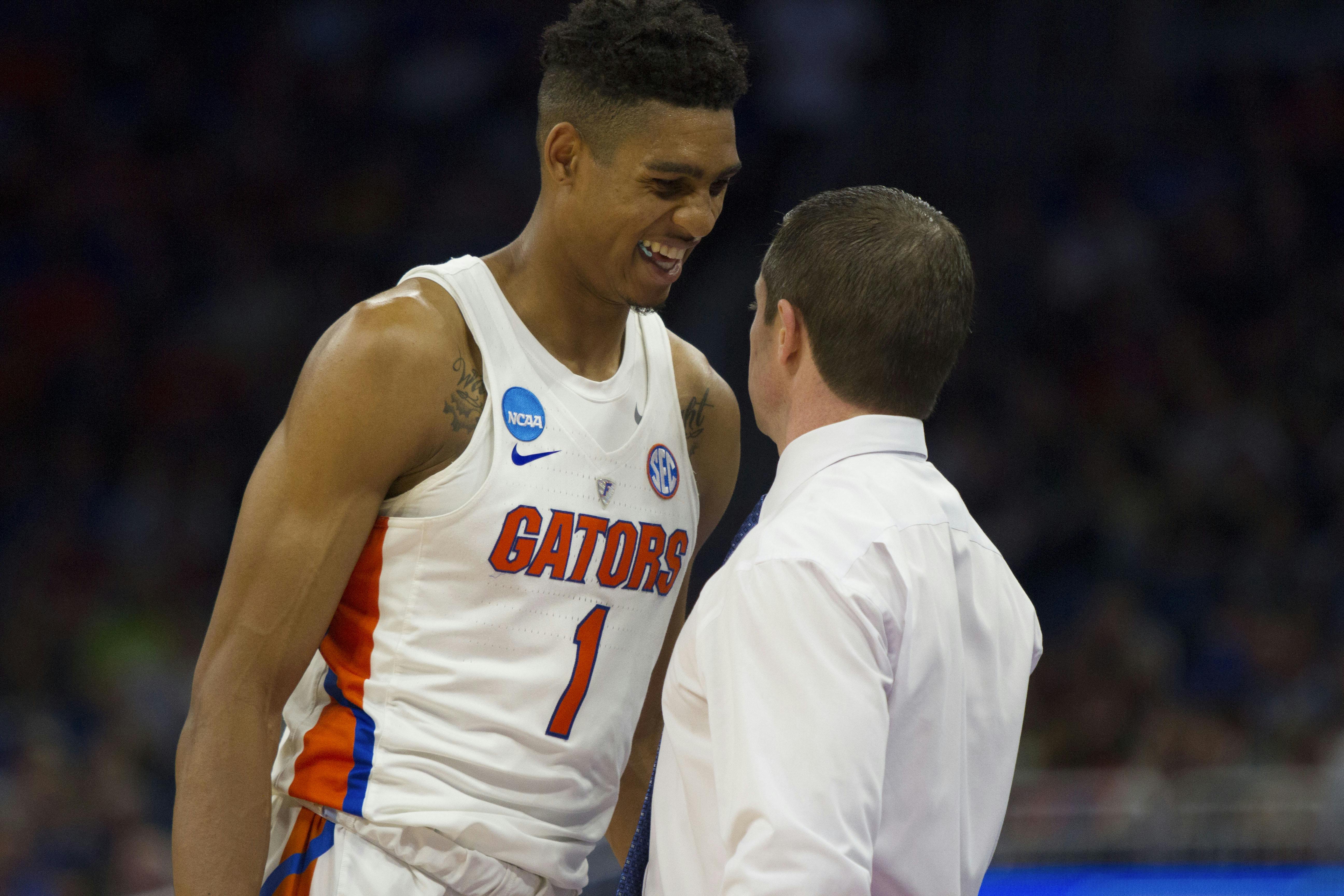 Devin Robinson smiles with UF coach Mike White in Florida's 65-39 win over Virginia in the Round of 32 in the NCAA Tournament on Saturday in Orlando. 