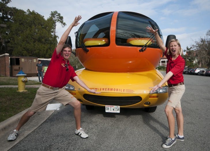 Oscar Mayer Hotdoggers Brian Keefe, aka Beefy Brian, and Traci Johnson, aka Tailgatin' Traci, Gator chomp in front of the Weinermobile.