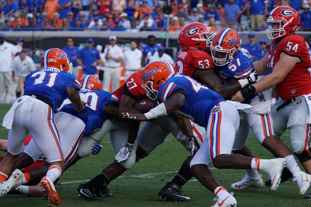 <p>Jarrad Davis (center) makes a tackle during Florida's 24-10 win over Georgia on Oct. 29, 2016, in Jacksonville.</p>