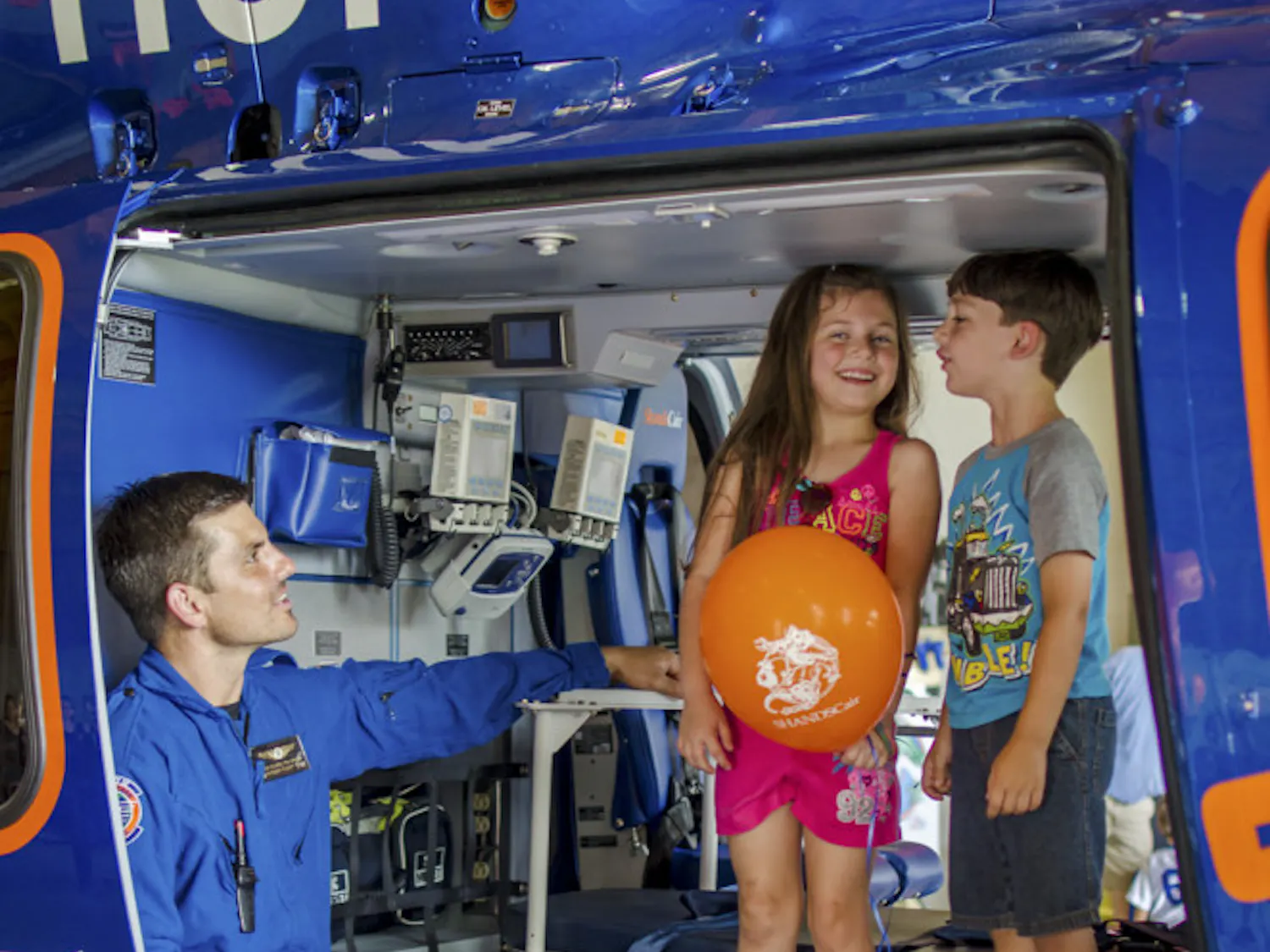 Flight Paramedic Jesse Blaire, 37, shows Snow Whitman, 6, and her brother Blaze, 5, the interior of Shands Hostpial's new EC-155 helicopter. The new model can travel 45 mph faster and can accommodate an extra patient and crew member, improving their capability to transport patients. ShandsCair held an open house on Saturday to celebrate the new addition.
