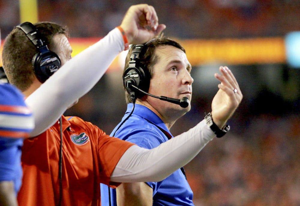 <p>Florida head coach Will Muschamp glances at the scoreboard during Florida's 30-27 loss to LSU on Saturday at Ben Hill Griffin Stadium.</p>
