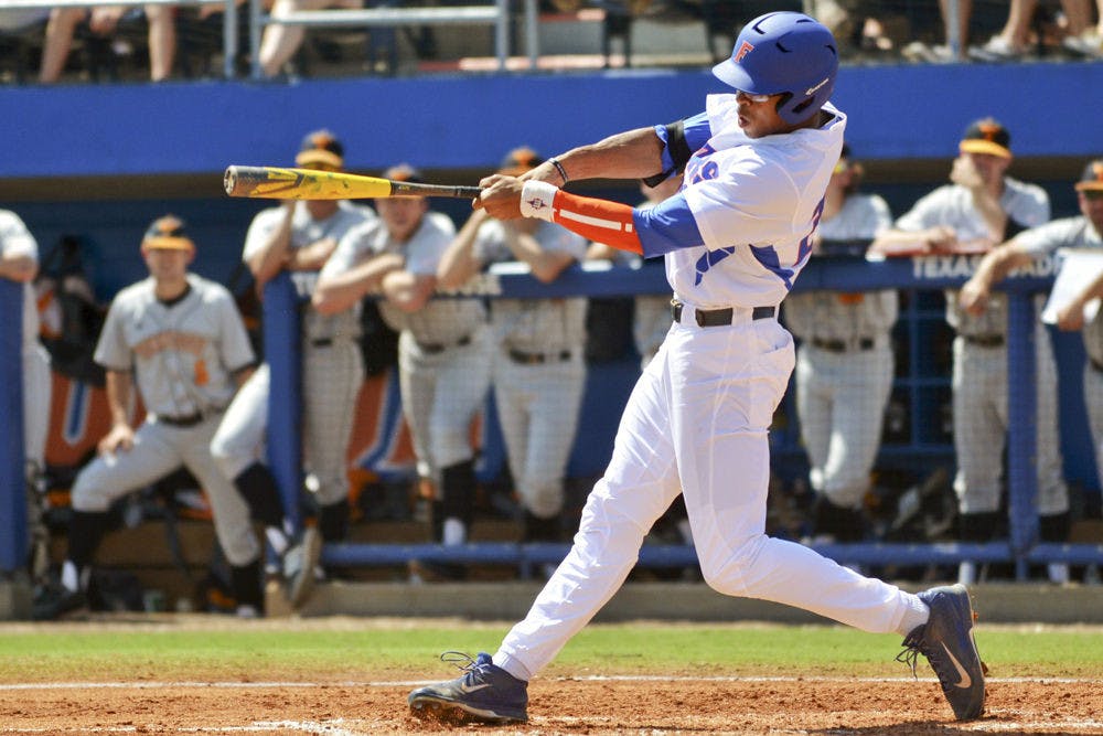 <p>Buddy Reed swings at a pitch during Florida's 9-4 win against Tennessee on March 15 at McKethan Stadium.</p>