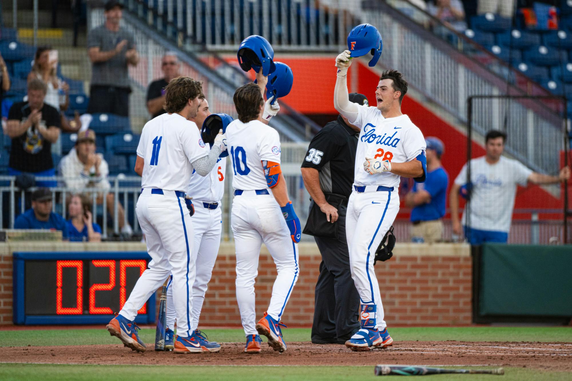 Florida Gators catcher Luke Heyman (28) is congratulated by his teammates after his home run in a baseball game against the Missouri Tigers on Thursday, April 10, 2025, in Gainesville, Fla.