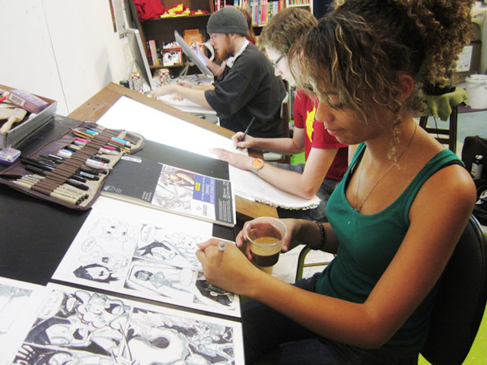 <p>Kyana Mitchell, 18, works on her comic about children who discover a mutated squid monster in their basement. Mitchell participated in 24-Hour Comics Day Saturday and Sunday at the Sequential Artists Workshop downtown.</p>