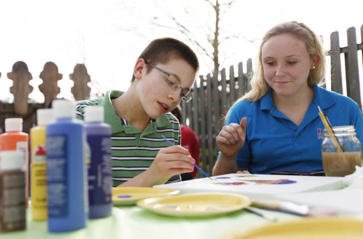 Michael Sayeski, 13, and Alexis Coryell, a 22-year-old UF finance senior, paint ice cream-themed artwork at Sweet Dreams’ new location, 1040 E. University Ave., on Monday in support of Dance Marathon.