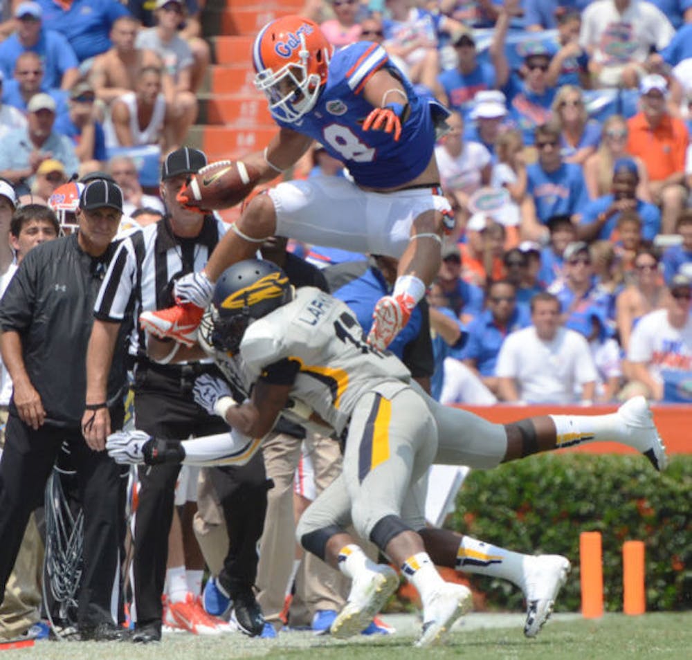 <p>Trey Burton jumps over two Toledo players during Florida’s 24-6 victory on Saturday in Ben Hill Griffin Stadium. Burton led all Gators receivers with five catches for 69 yards.</p>